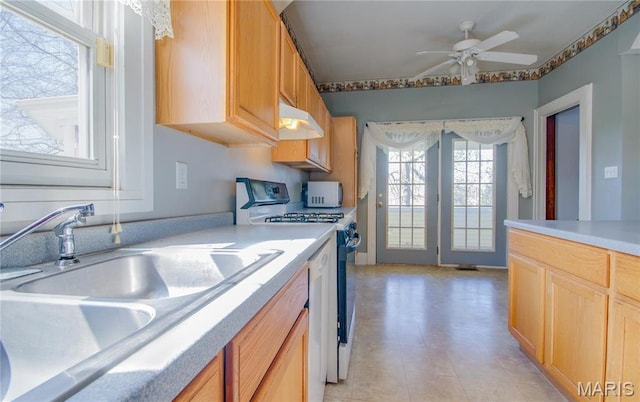 708 E Fillmore St E, Fillmore, IL 62032 - kitchen with range with gas cooktop, under cabinet range hood, white microwave, a ceiling fan, and light countertops