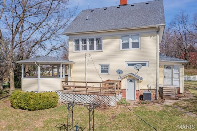 708 E Fillmore St E, Fillmore, IL 62032 - rear view of property featuring roof with shingles, a chimney, a deck, central AC, and a lawn