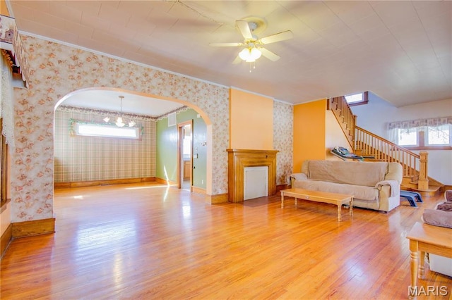 708 E Fillmore St E, Fillmore, IL 62032 - living room featuring wallpapered walls, light wood-style flooring, stairs, ornamental molding, and a ceiling fan