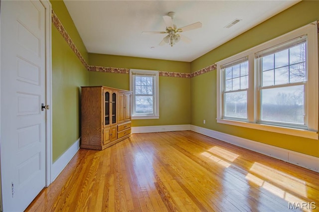708 E Fillmore St E, Fillmore, IL 62032 - spare room featuring light wood-type flooring, ceiling fan, and baseboards