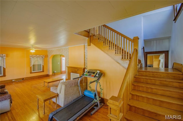 708 E Fillmore St E, Fillmore, IL 62032 - exercise area with wood finished floors, arched walkways, and a ceiling fan