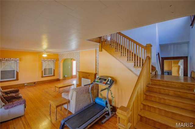 708 E Fillmore St E, Fillmore, IL 62032 - living room featuring arched walkways, wood finished floors, stairway, a ceiling fan, and baseboards