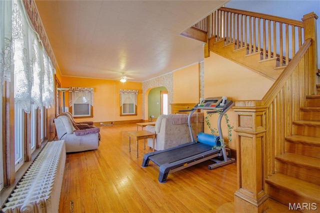 708 E Fillmore St E, Fillmore, IL 62032 - exercise room featuring arched walkways, light wood finished floors, a ceiling fan, and baseboards