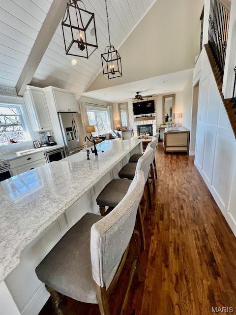 1437 Palisades Rd, Wildwood, MO 63021 - kitchen with open floor plan, a fireplace, white cabinets, dark wood-style floors, and wood ceiling