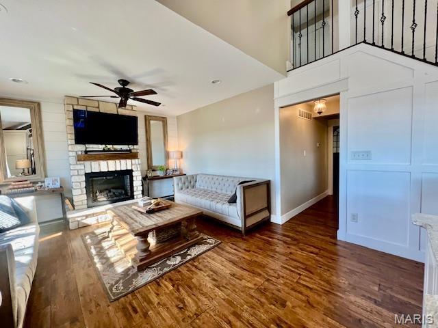 1437 Palisades Rd, Wildwood, MO 63021 - living room featuring a ceiling fan, a fireplace, wood finished floors, and baseboards