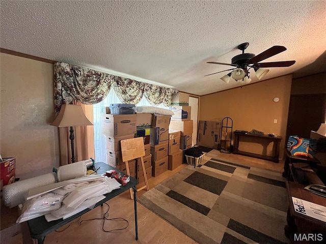 bedroom with a textured ceiling, wood finished floors, vaulted ceiling, and ceiling fan