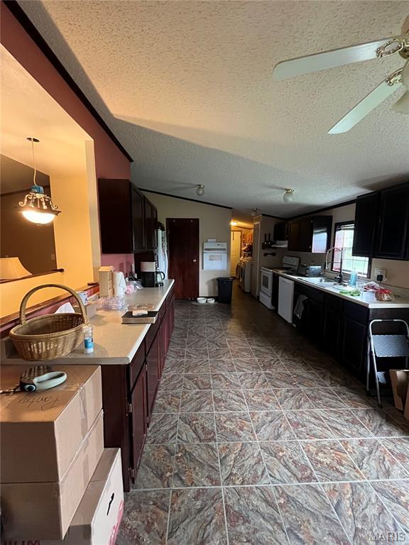 kitchen with a textured ceiling, light countertops, electric stove, and ceiling fan
