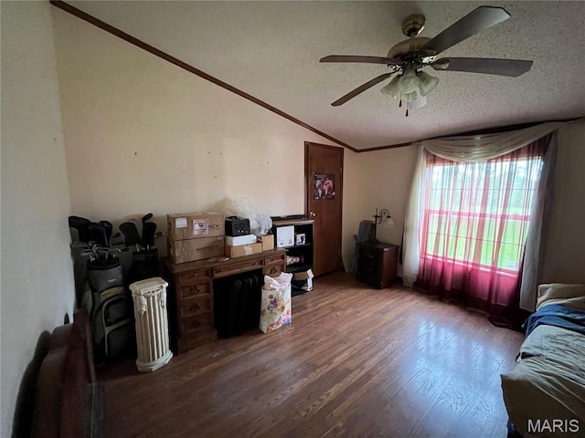 living room featuring wood finished floors, a ceiling fan, vaulted ceiling, ornamental molding, and a textured ceiling