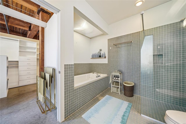 full bathroom featuring walk in shower, a garden tub, tile patterned floors, toilet, and tile walls
