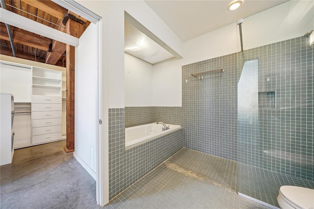 bathroom with a bath, a tile shower, toilet, and tile patterned flooring