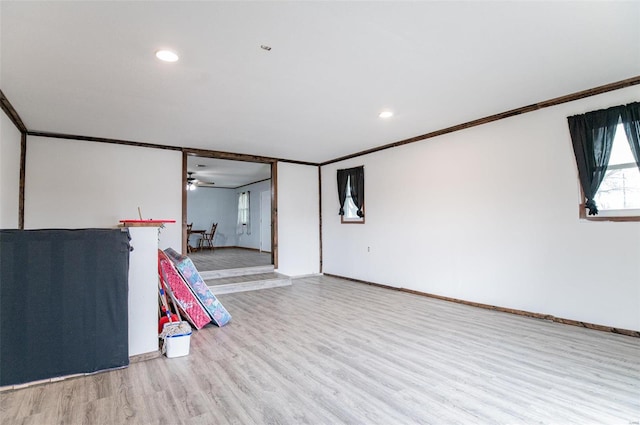 empty room with wood finished floors, ceiling fan, crown molding, recessed lighting, and baseboards