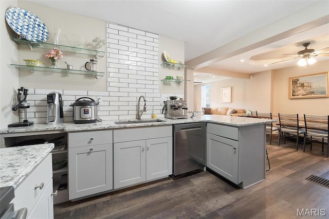 kitchen with dishwasher, open shelves, a peninsula, a sink, and dark wood-type flooring