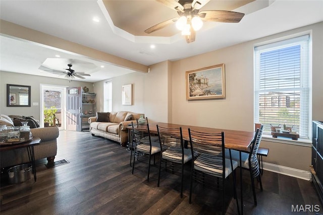 dining space with a tray ceiling, ceiling fan, dark wood finished floors, healthy amount of natural light, and recessed lighting