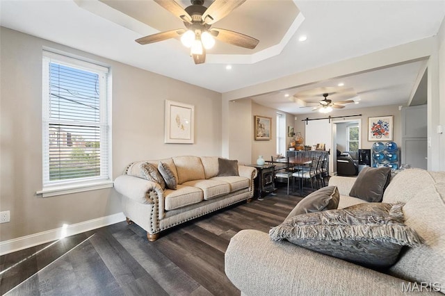 living room featuring ceiling fan, dark wood-style flooring, baseboards, a raised ceiling, and recessed lighting