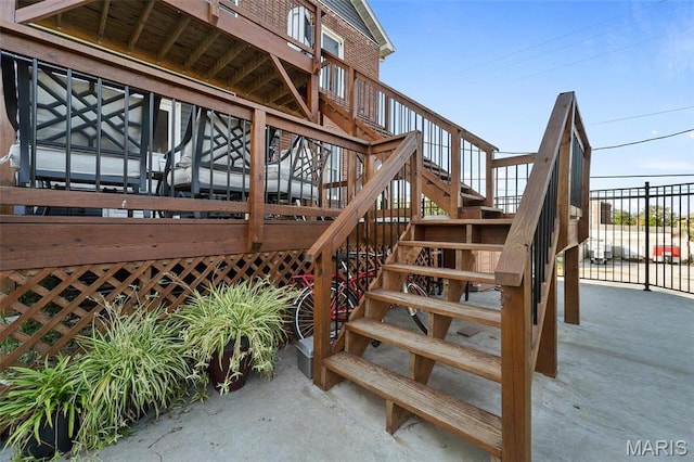wooden terrace featuring stairway and fence