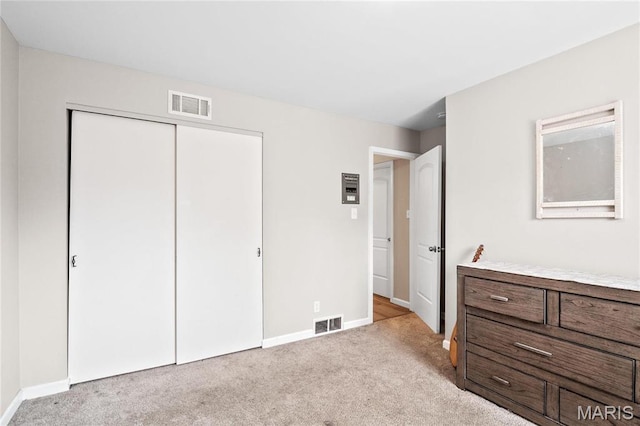 13507 Coliseum Dr Unit F, Chesterfield, MO 63017 - bedroom with light carpet, baseboards, and a closet