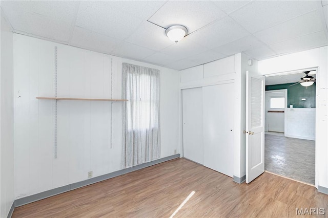 8432 Tennessee Ave, Saint Louis, MO 63125 - unfurnished bedroom featuring light wood-style flooring, a paneled ceiling, a closet, and baseboards
