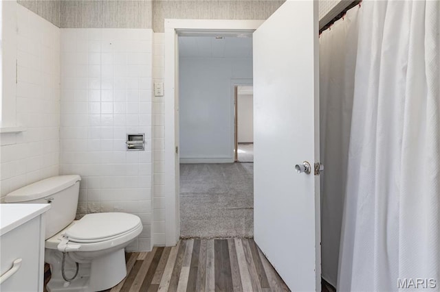 8432 Tennessee Ave, Saint Louis, MO 63125 - bathroom with wood finished floors, toilet, tile walls, and vanity