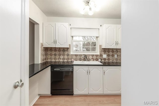 13555 Coliseum Dr Unit G, Chesterfield, MO 63017 - kitchen featuring dishwasher, a sink, dark countertops, white cabinets, and a textured ceiling