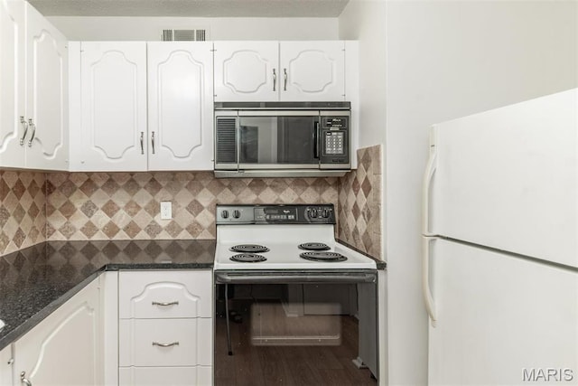 13555 Coliseum Dr Unit G, Chesterfield, MO 63017 - kitchen featuring stainless steel microwave, electric stove, freestanding refrigerator, dark countertops, and white cabinets