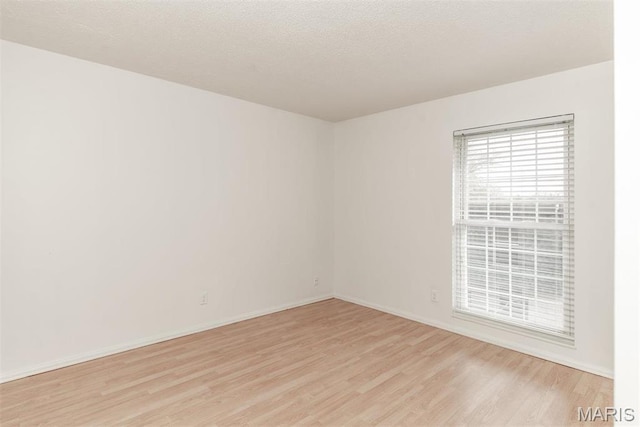 13555 Coliseum Dr Unit G, Chesterfield, MO 63017 - spare room with light wood-style flooring and baseboards