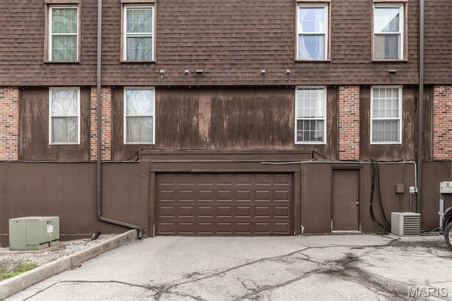 13555 Coliseum Dr Unit G, Chesterfield, MO 63017 - exterior space featuring an attached garage, asphalt driveway, and brick siding