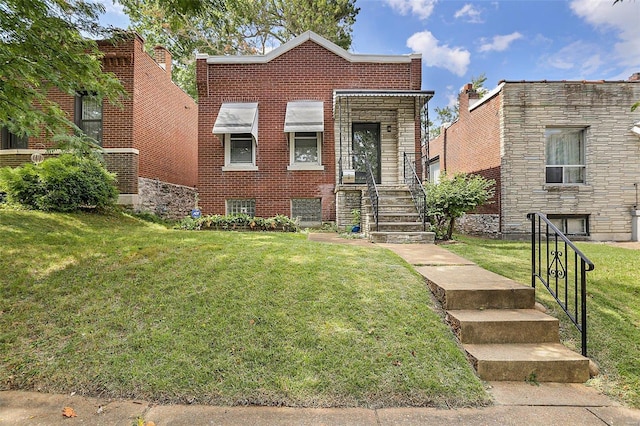 4242 Walsh St, Saint Louis, MO 63116 - view of front facade featuring a front lawn and brick siding
