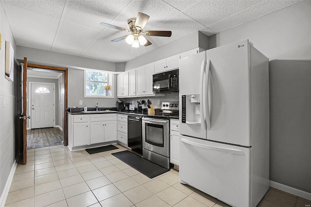 4242 Walsh St, Saint Louis, MO 63116 - kitchen with black appliances, dark countertops, and white cabinetry