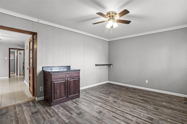 4242 Walsh St, Saint Louis, MO 63116 - unfurnished room featuring ceiling fan, dark wood-type flooring, crown molding, and baseboards