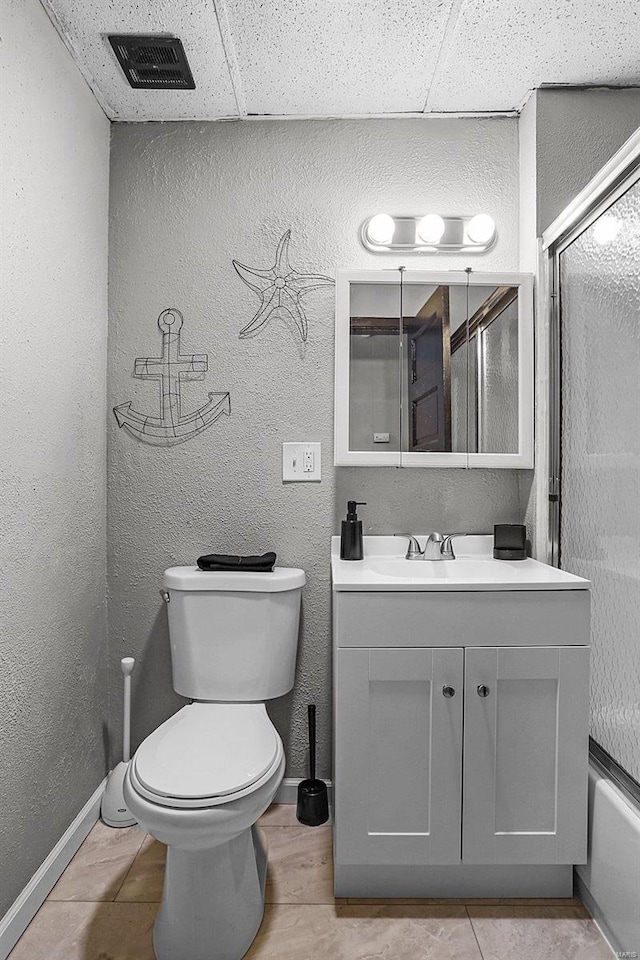 4242 Walsh St, Saint Louis, MO 63116 - bathroom featuring vanity, toilet, a shower with shower door, a textured wall, and baseboards