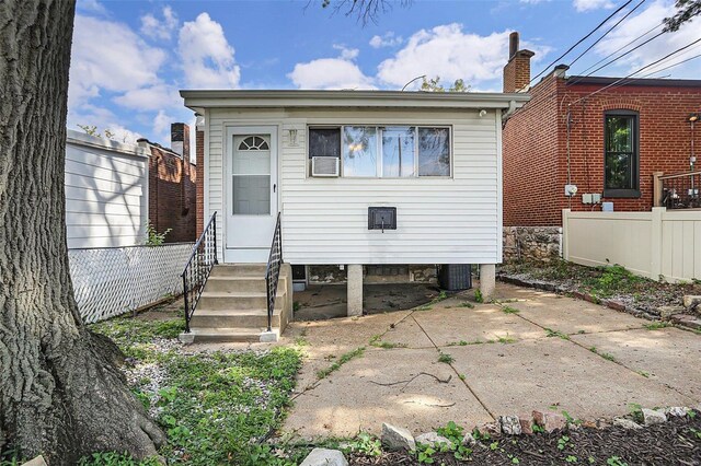 4242 Walsh St, Saint Louis, MO 63116 - view of front facade featuring fence, entry steps, and a patio area