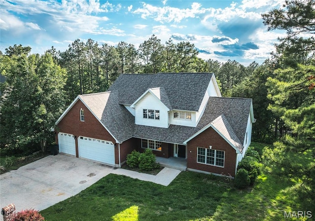 10625 Pine Needle Cir, Rolla, MO 65401 - traditional-style house featuring brick siding, covered porch, concrete driveway, a front yard, and an attached garage