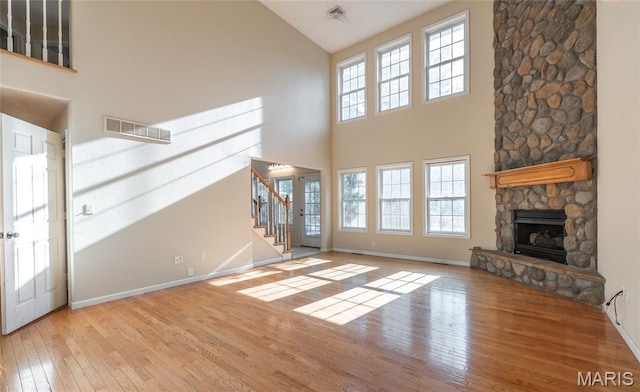 10625 Pine Needle Cir, Rolla, MO 65401 - unfurnished living room featuring high vaulted ceiling, hardwood / wood-style floors, plenty of natural light, and baseboards