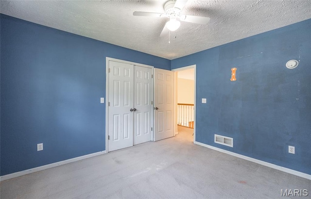 10625 Pine Needle Cir, Rolla, MO 65401 - unfurnished bedroom with a textured ceiling, baseboards, a closet, carpet floors, and a ceiling fan
