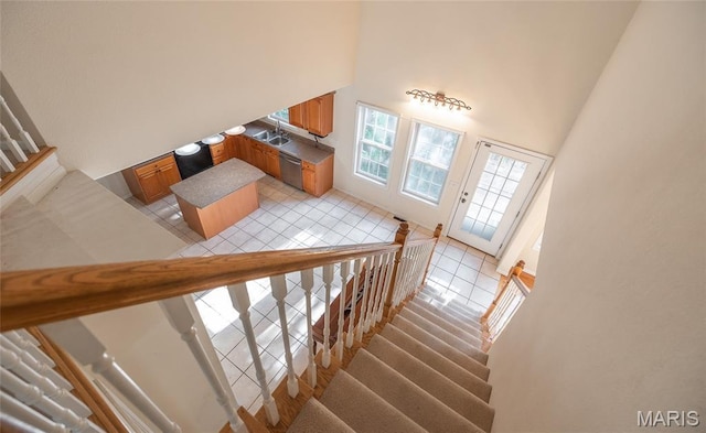 10625 Pine Needle Cir, Rolla, MO 65401 - staircase featuring tile patterned flooring and a towering ceiling