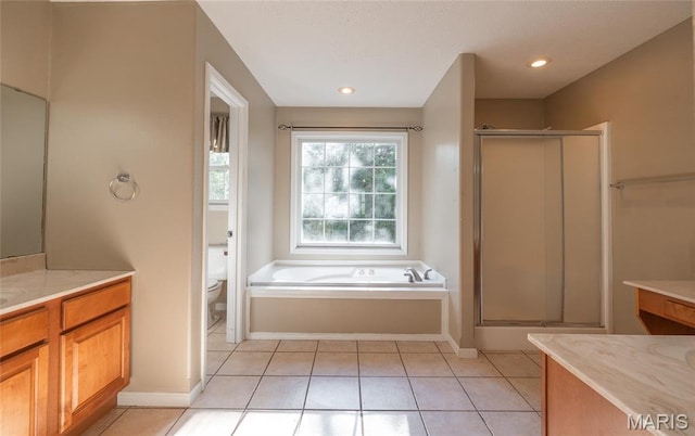 10625 Pine Needle Cir, Rolla, MO 65401 - bathroom featuring a garden tub, tile patterned flooring, a shower stall, vanity, and toilet