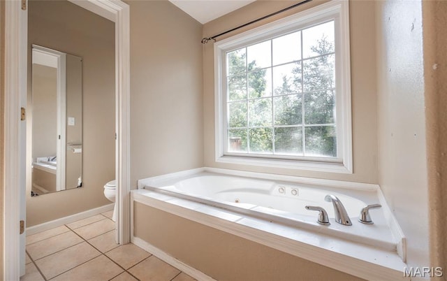 10625 Pine Needle Cir, Rolla, MO 65401 - bathroom with toilet, a whirlpool tub, tile patterned floors, and baseboards