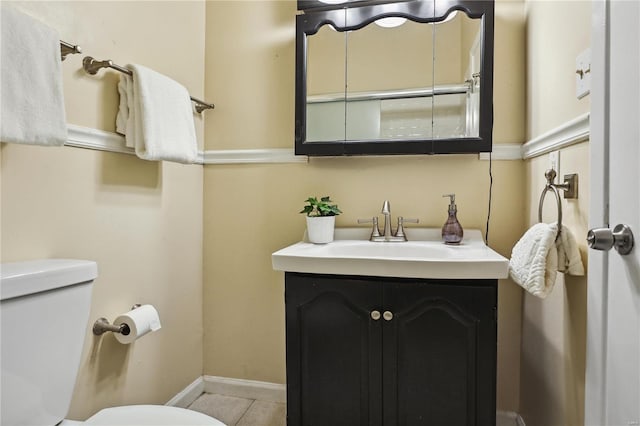 3944 Russell Blvd, Saint Louis, MO 63110 - half bathroom featuring toilet, vanity, baseboards, and tile patterned floors
