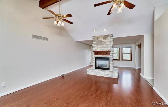 unfurnished living room with ceiling fan, wood finished floors, a fireplace, and baseboards
