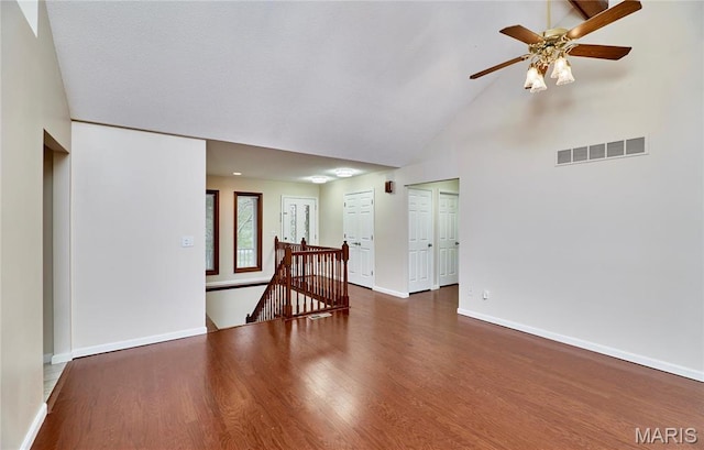 unfurnished room featuring high vaulted ceiling, baseboards, a ceiling fan, and wood finished floors