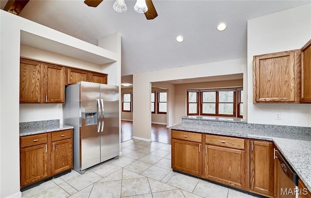 kitchen with stainless steel fridge with ice dispenser, dishwashing machine, ceiling fan, brown cabinetry, and lofted ceiling