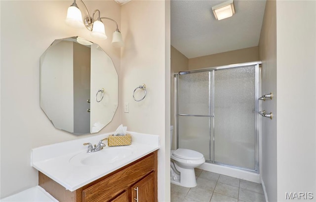 full bath with tile patterned flooring, a stall shower, toilet, and vanity