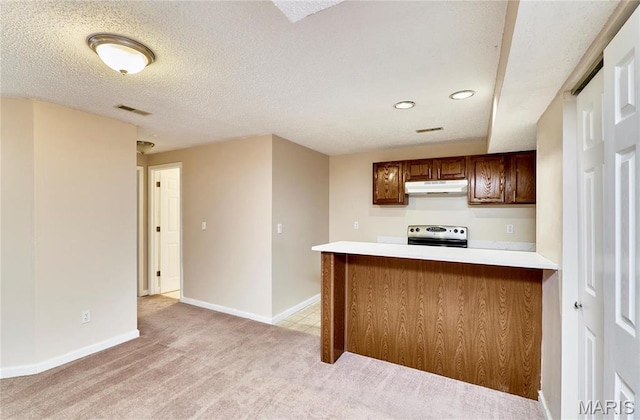 kitchen with stainless steel electric range, under cabinet range hood, light colored carpet, light countertops, and recessed lighting
