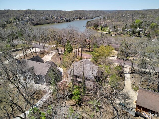 aerial view of property and surrounding area featuring a large body of water