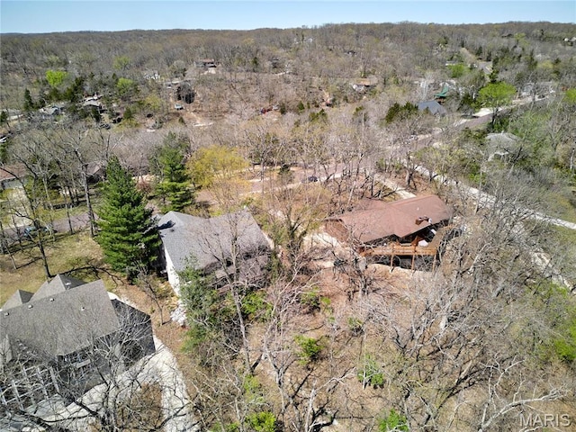 aerial view of property's location featuring a forest