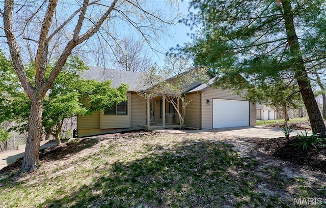157 S Kings Rd, Lake Sherwood, MO 63357 - view of front of home featuring covered porch, a garage, and concrete driveway