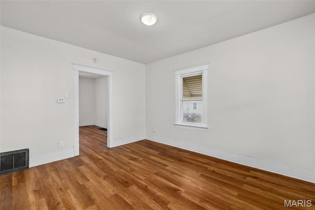 6546 Joseph Ave, Saint Louis, MO 63133 - spare room featuring wood finished floors and baseboards
