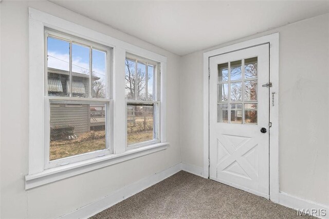 6546 Joseph Ave, Saint Louis, MO 63133 - doorway with plenty of natural light, baseboards, and dark carpet