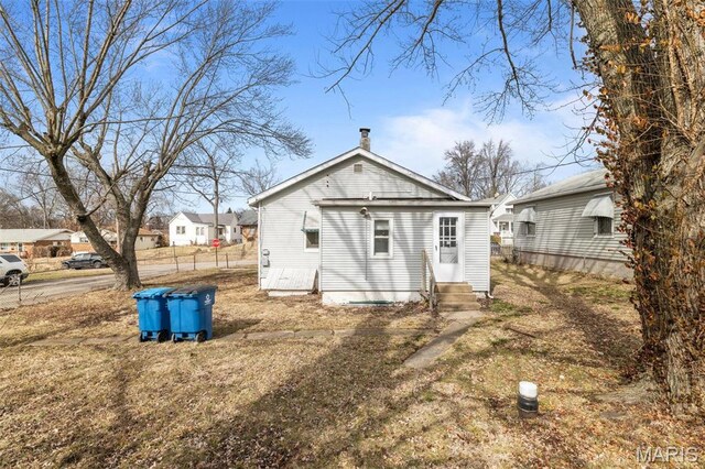 6546 Joseph Ave, Saint Louis, MO 63133 - rear view of house with entry steps and a chimney