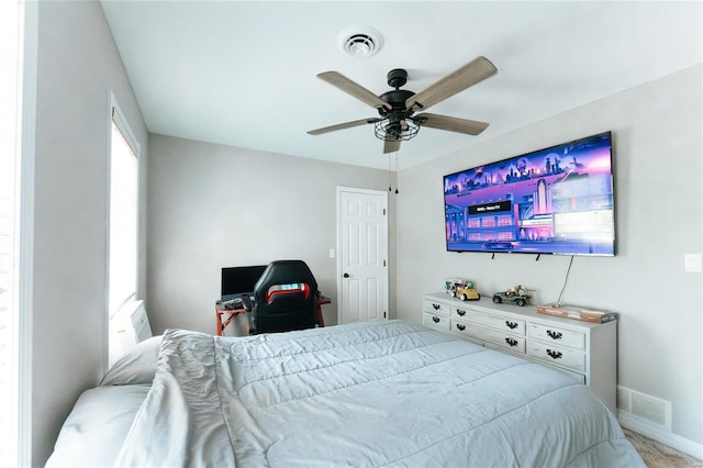 bedroom with baseboards and a ceiling fan